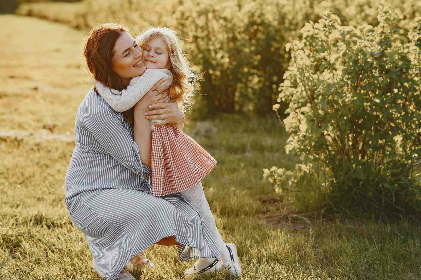 A parent and child sharing a quiet, supportive moment outdoors, illustrating the peace of mind provided by living benefit insurance.